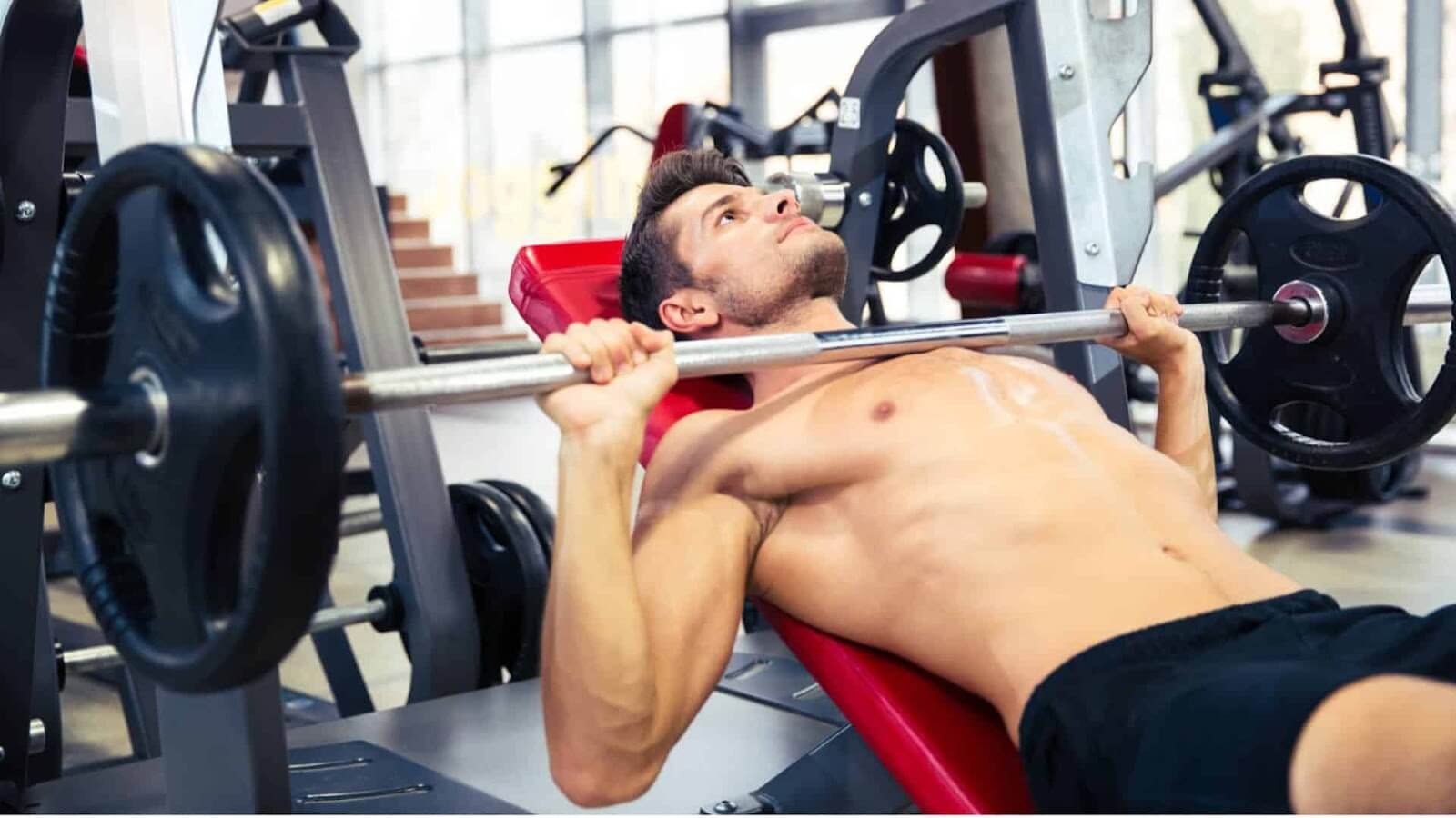 A man does incline barbell press