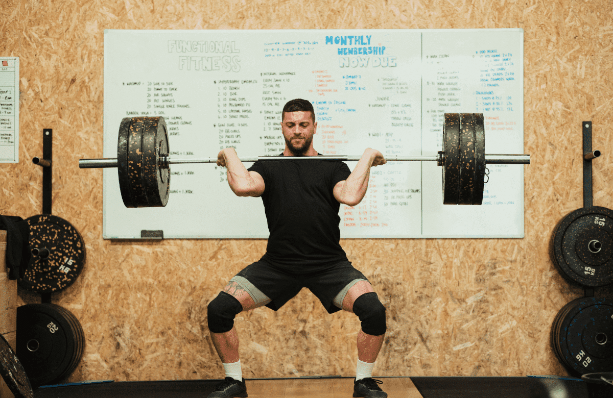 A man does a hang clean in a crossfit gym