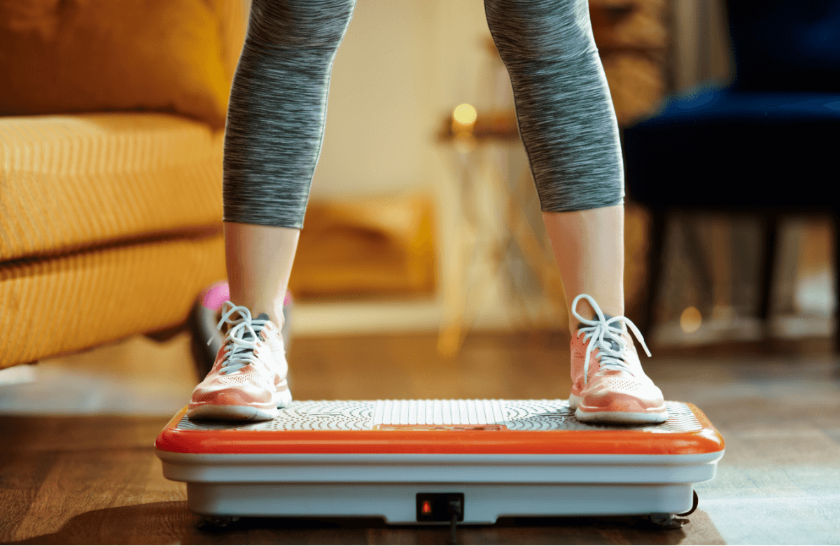 A woman trains on a vibration plate