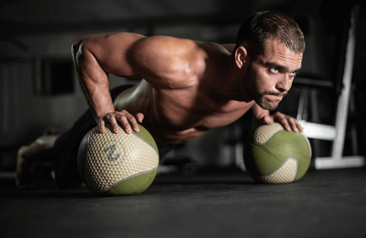 A man does push-ups on fitness balls